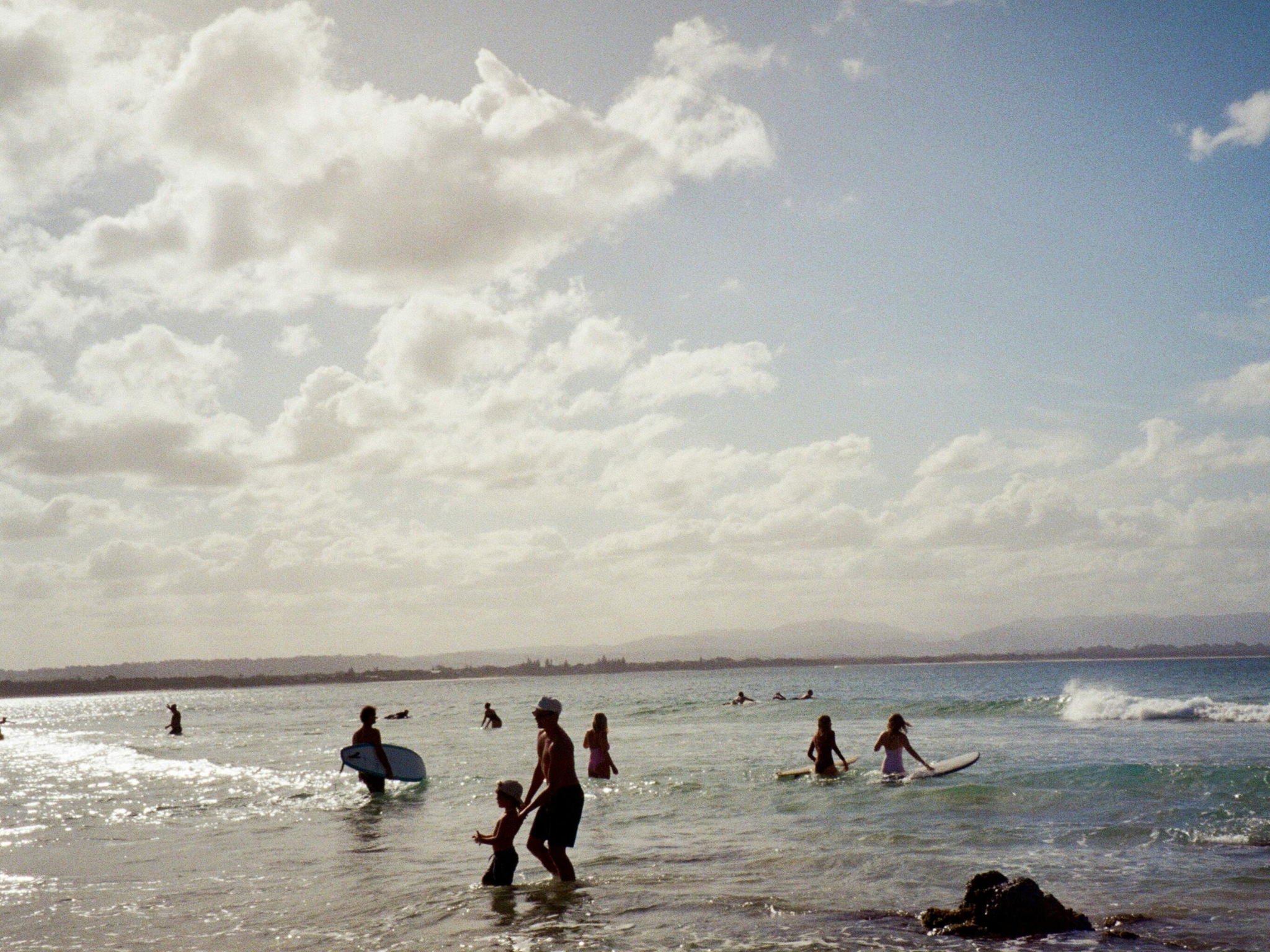 A portable rechargeable pump inflating a stand-up paddleboard, highlighting ease and convenience for water sports enthusiasts.